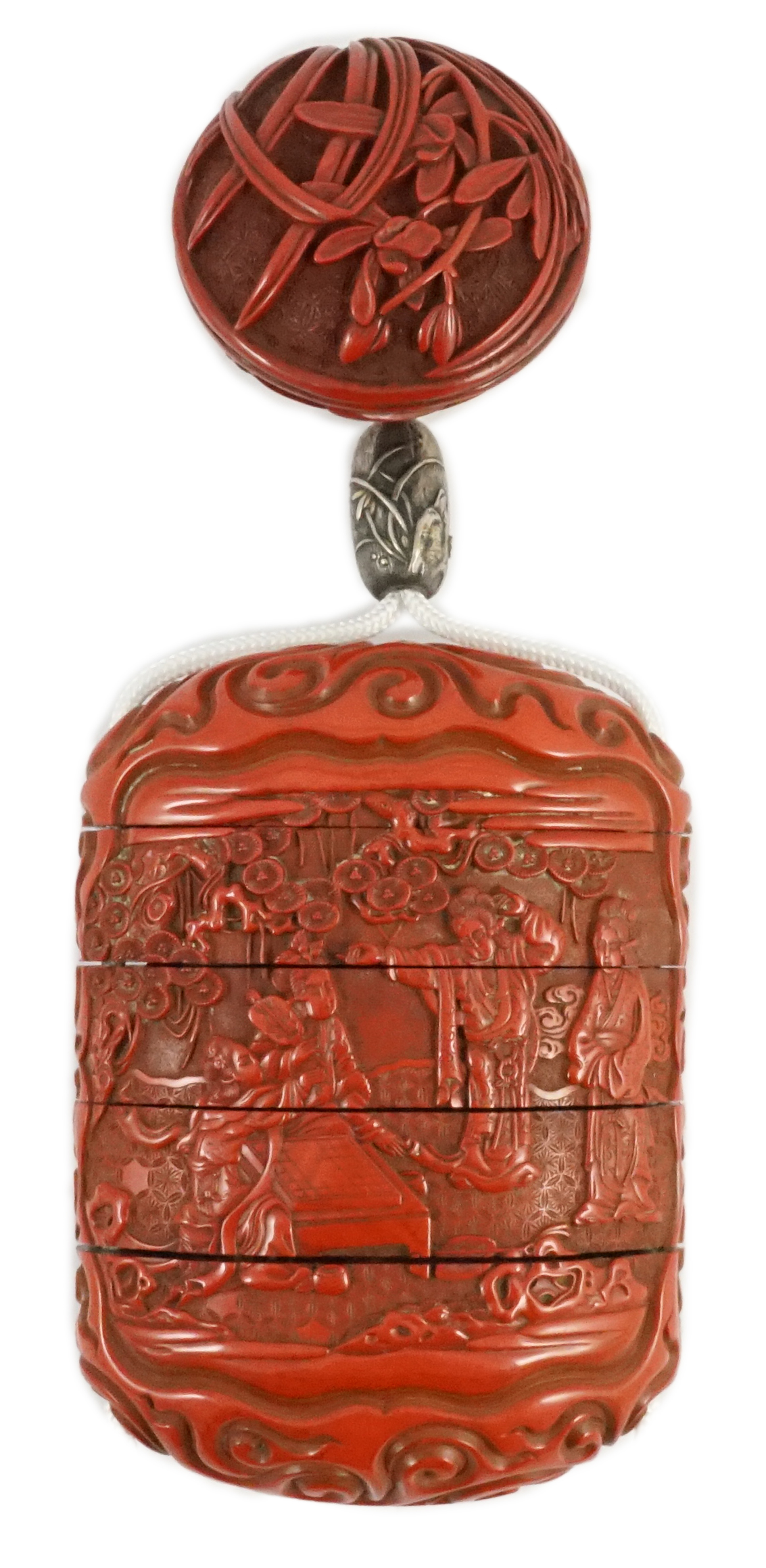 A good Japanese tsuishu (carved red lacquer) four case inro, by Yosei, and a similar manju netsuke, 19th century